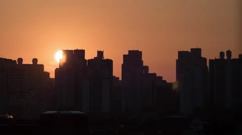 Time lapse shot of sun rising and moving in the sky, city modern buildings on Stock Footage 67200982