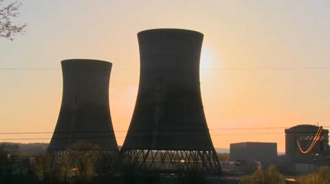Time lapse shot of the sun setting behind a nuclear power plant. Stockbeeldmateriaal 8516374