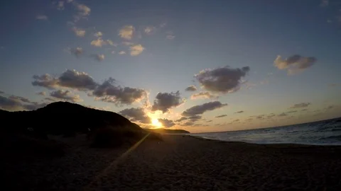 Time lapse shot of sun setting on the beach clouds passing Stock Footage 82088677