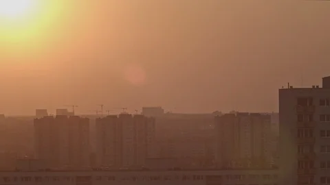 Time lapse shot of the sunset. The sun hides behind the buildings 4k 50fps Stock-Footage 105967570