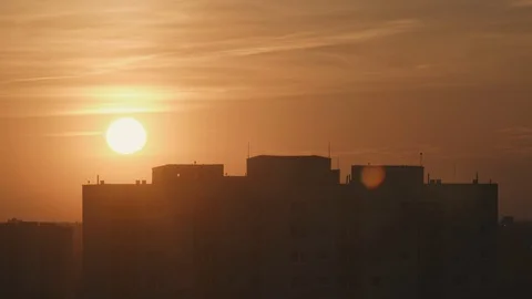Time lapse shot of the sunset. The sun hides behind the buildings 4k 50fps Stock-Footage 106454105