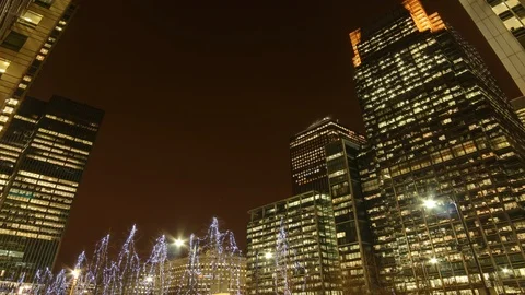 Time lapse shot tilted up towards lit up city buildings, night Stock Footage 101805882