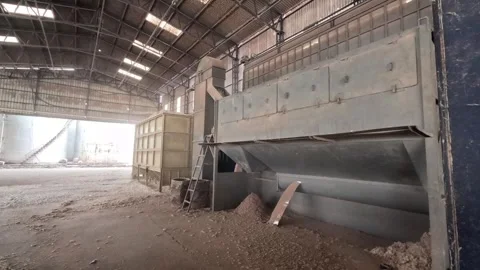 A time lapse shot of truck unloading a cotton seed in cleaning machine. Stock Footage 313913449