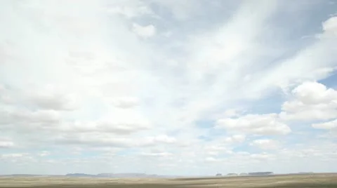 Time lapse shot of white clouds moving over the desert in Shiprock, New Mexico. Stock Footage