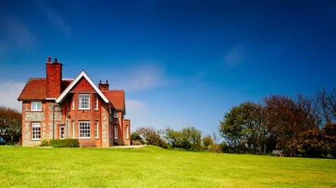 Time lapse showing clouds moving over cottage Stock Footage 10590471