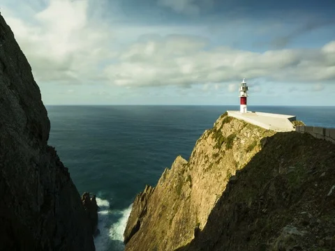 Time lapse showing a lighthouse, water and drifting clouds. Stock Footage 77917020