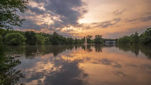 Time lapse showing the moving clouds during sunset over the park. Stock Footage 245975968