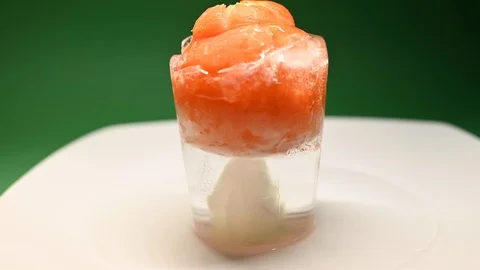 Time-lapse that shows how ice cubes melt with a tomato Stock Footage 115096280