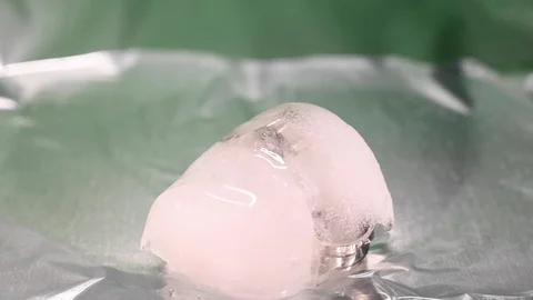 Time-lapse that shows how ice cubes melt with 2 wedding bands Stock Footage 115104916