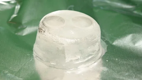 Time-lapse that shows how ice cubes melt with 2 wedding rings Stock Footage 115111897