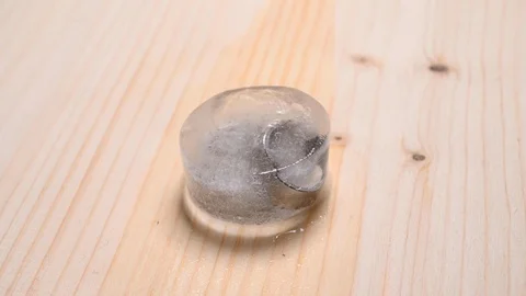 Time-lapse that shows how ice cubes melt with 2 wedding bands Stock Footage 115122222