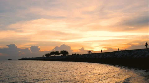 Time lapse of silhouette people and family walking on the bridge over the sea Stock Footage 135374853