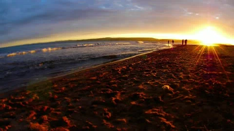 Time lapse of silhouetted children playing by the sea at sunset. Stock Footage 10872157