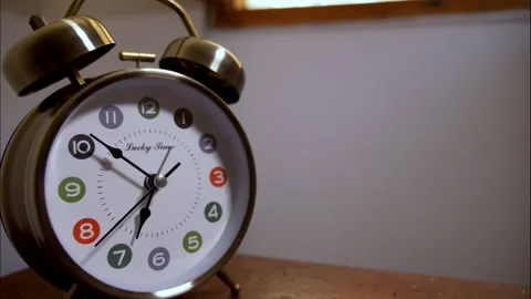 Time-Lapse of a Silver Vintage Clock on a Table by an Open Window Stock Footage 337194079