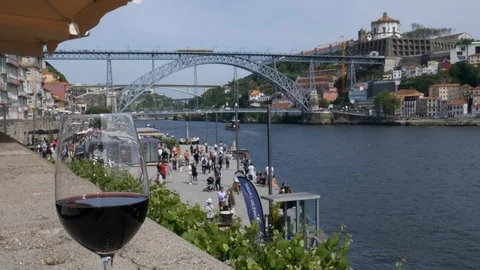 Time lapse of single red wine glass overlooking tourists at Cais da Ribeira Stock Footage 107277032