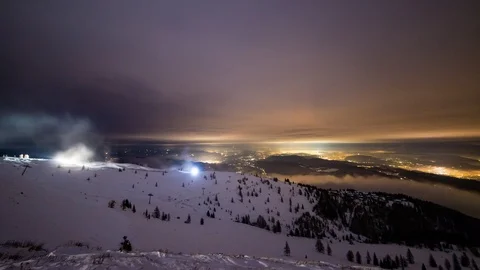 Time Lapse - Ski area at night with a view down the mountain and snow canons Stock Footage 99361470
