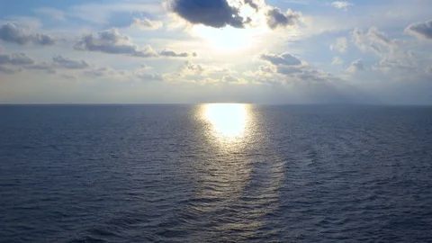 Time lapse of sky and sunset sea furrowed by a cruise ship waves Video stock 119425620