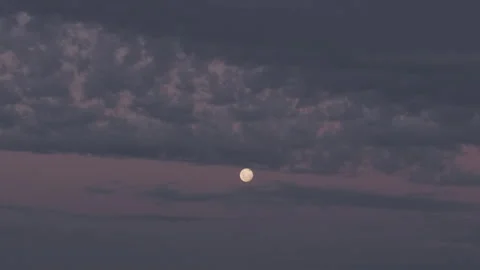 Time lapse of the sky at dusk, cloud and the moon contrasting with colors Stock Footage 262543241