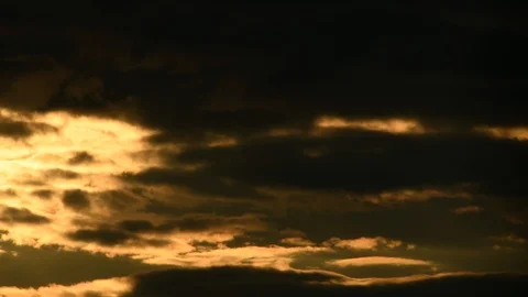 Time lapse - Sky gets covered by dark clouds during red sunset Stock-Footage 94477460