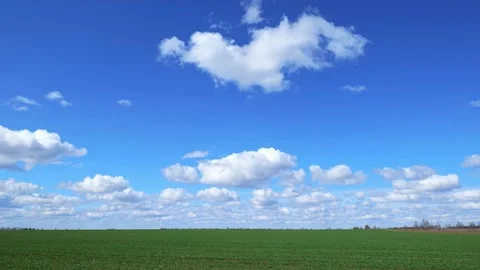 Time lapse of the sky over a green field in spring Stock Footage 184081765