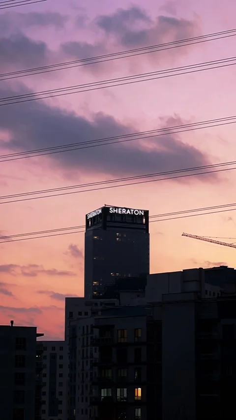 Time Lapse of Sky over Sheraton Hotel in Evening Stock Footage 201317737