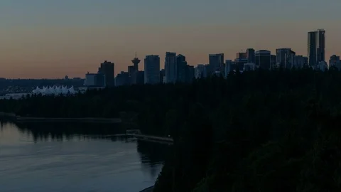 Time lapse of sky over Vancouver BC and Stanley Park water reflection at sunrise Stock Footage 91252913