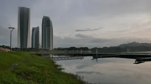 Time lapse skyscraper building by the lake with a misty and cloudy morning. Stock Footage 60111369