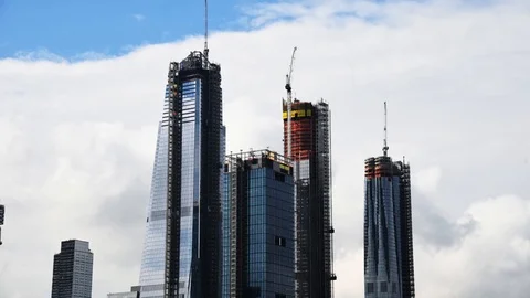 Time Lapse skyscrapers under construction against moving clouds Stock Footage 94844464
