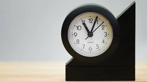 Time lapse of a small clock on a wooden table. Stock Footage 69056883