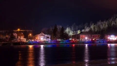 Time lapse of small town at night during the holidays with river in foreground Stock Footage 71256722