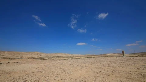 Time-lapse small white clouds moving over desert Stock Footage 104271391