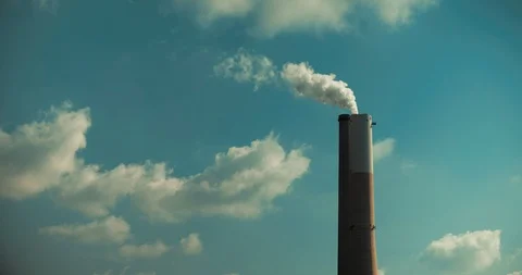 Time lapse of a smoke coming out of a power plant chimney, clouds and blue sky Stock Footage 121473708