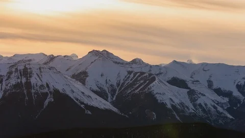 Time lapse of snow blowing on mountain peaks in distance at sunset Stock Footage 74183042
