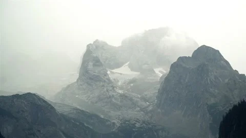 Time Lapse of Snow-capped mountain peak in fog Stock-Footage 121483823