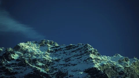 Time lapse of snow capped mountains peaks against blue sky in the Alps Видео 101514606