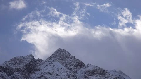 Time-lapse of snow-covered mountain with moving clouds Stock Footage 310230634