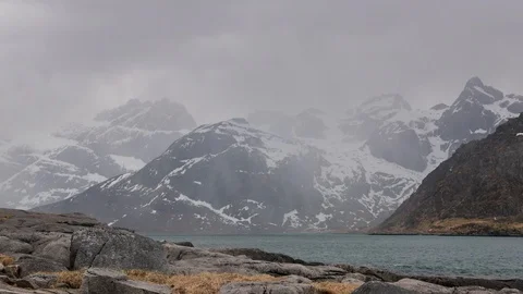 Time lapse of a snow flurry over a lake in Lofoten Stock Footage 112720650