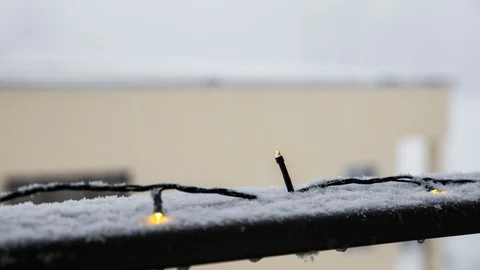 Time Lapse - Snowfall in winter with christmas lights Stock Footage 99369696