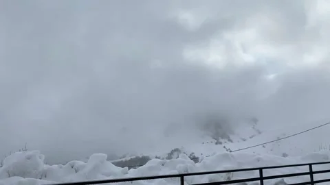Time lapse in snowy weather, clouds over the mountain Stock Footage 152486607