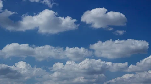 Time-lapse of Soft white clouds moving rapidly over a vibrant blue backdrop Stock Footage 321226517