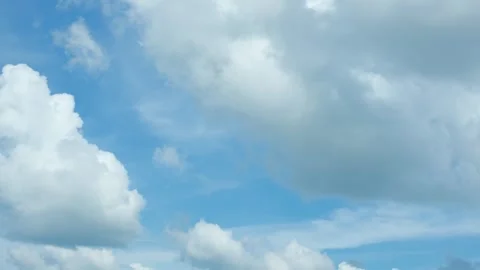 Time lapse of soft white cumulus clouds move in the blue sky. Background of Stock Footage 279804218