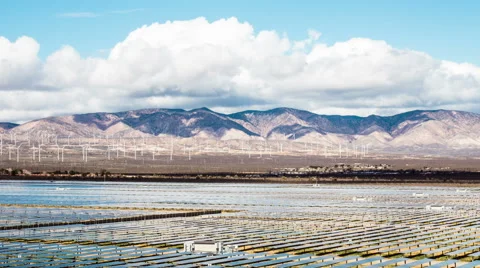 Time Lapse - Solar Panel with Wind Turbine with Mountain Range Stock Footage 52044576