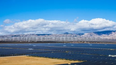 Time Lapse - Solar Panel with Wind Turbine with Mountain Range - 4K Stock Footage 106014359