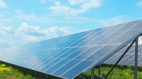 Time lapse of solar panels absorbing sunlight on a clear day in an open field Stock Footage 309143568