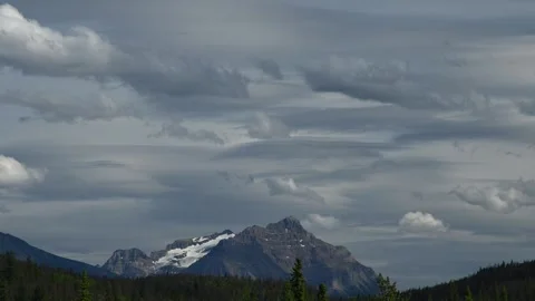 Time lapse of spectacular lenticular and other clouds moving above a rocky mount Stock Footage 274675178