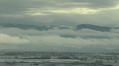 Time Lapse of Spooky Low Clouds over Valley after Winter Storm Stock Footage 54734089
