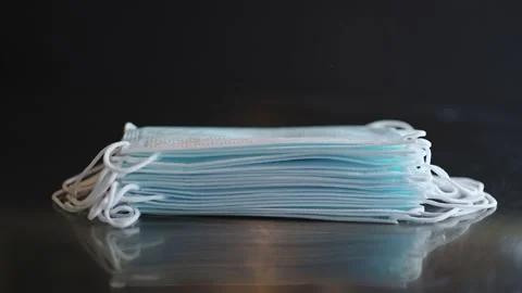 Time lapse a stack of blue close-up medical protective masks Stock Footage 148826623