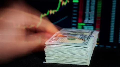 Time Lapse of Stack of Dollar Falling Against Background of Cryptocurrency Chart Stock Footage 260940220