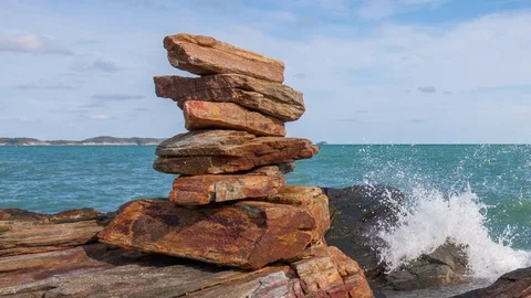 Time lapse of stacking stone balance beside water splash from sea day , Zoom Stock Footage 113342522