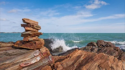 Time lapse of stacking stone balance beside water splash from sea day , Stock Footage 113342613